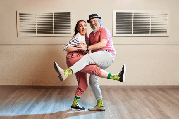 A man and a woman dancing Lindy Hop in a dance studio