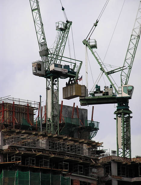 construction work building construction work, with two cranes turnkey project stock pictures, royalty-free photos & images