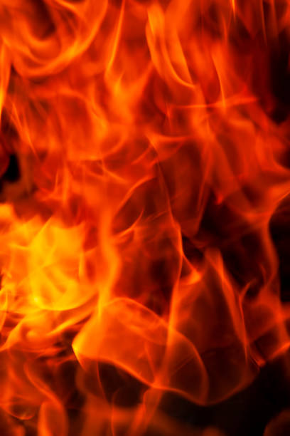 istock orange flame of fire while burning branches and firewood 1390912614