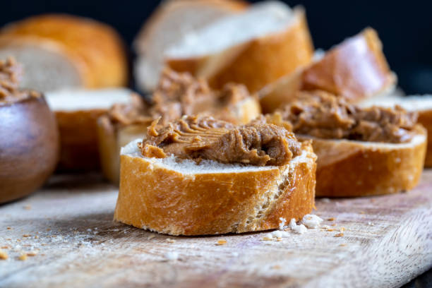 istock peanut paste with pieces of peanuts and white baguette 1390912655