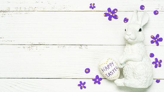 The concept of a happy, bright Easter holiday. Easter composition spring flowers eggs on white background.