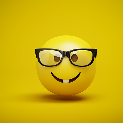 3d render of an emoji smiley with a nerd face with glasses.
