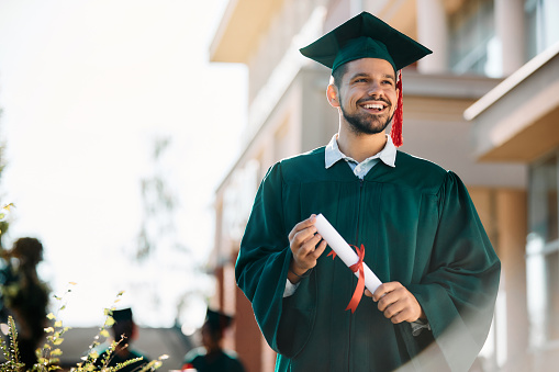 Graduation, success and black man or students at university for study goal, certificate achievement or diploma award scholarship. College or academy class graduate group in an outdoor campus portrait