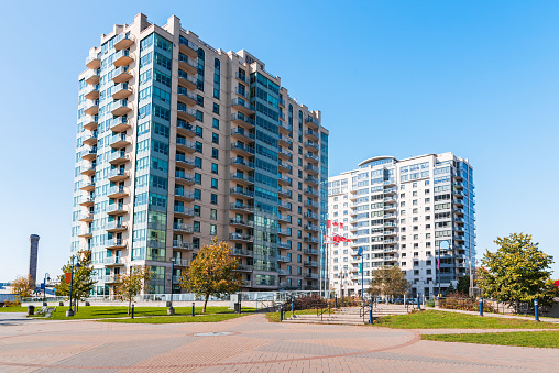 Modern apartment buildings under cloudless blue sky in autumn