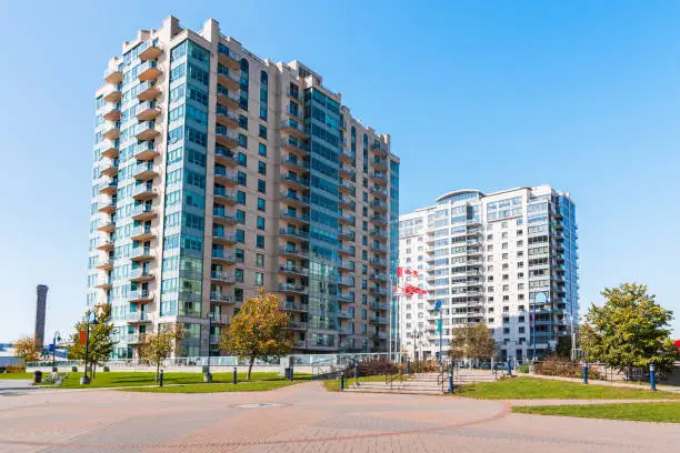 Photo of Modern apartment buildings under cloudless blue sky in autumn