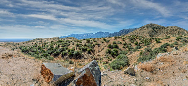 San Augustin Mountains The San Augustin Mountains are an eight-mile-long subrange located at the southern end of the San Andres Mountains.  This view of the San Augustin Mountains was photographed from San Augustin Pass located east of Las Cruces, New Mexico, USA. jeff goulden panoramic stock pictures, royalty-free photos & images