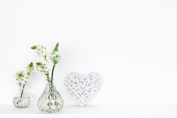 istock Spring flowers in glass vases isolated on white background. 1390920698