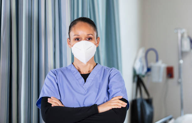 istock Female nurse wearing N95 face 1390921504