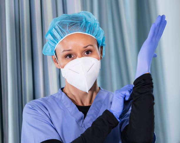 istock Female nurse putting on surgical gloves 1390921537