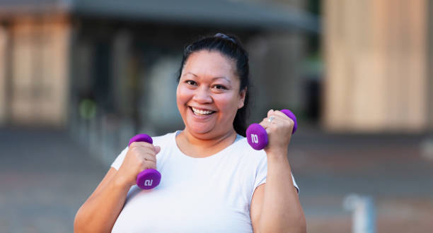 istock Pacific Islander woman exercising with dumbbells 1390921572