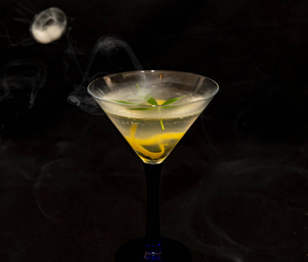 istock Cannabis infused martini cocktail on black background 1390921585