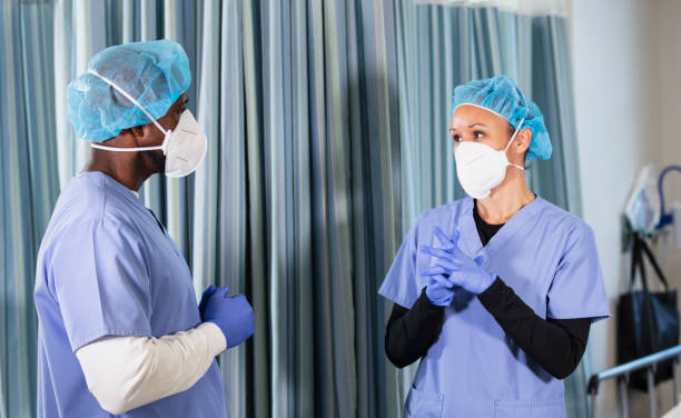 istock Two multiracial nurses in N95 face masks conversing 1390921622