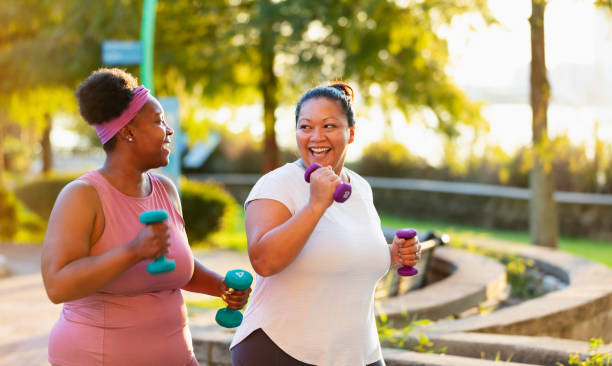 Two multiracial women exercising in city, jogging