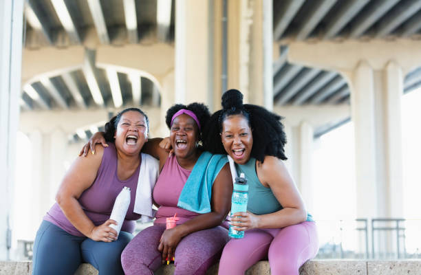 istock Three multiracial women sit together after workout 1390922400
