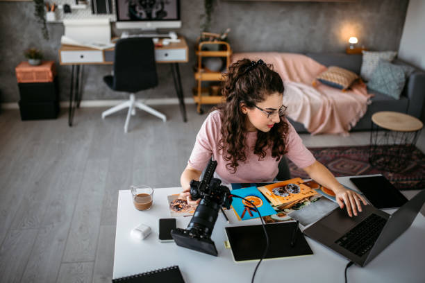 istock Photographer choosing photos for printing 1390922646