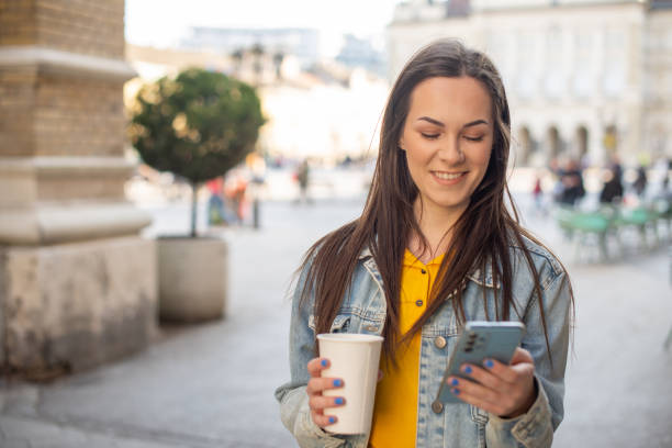 istock Happy young woman using phone 1390925898