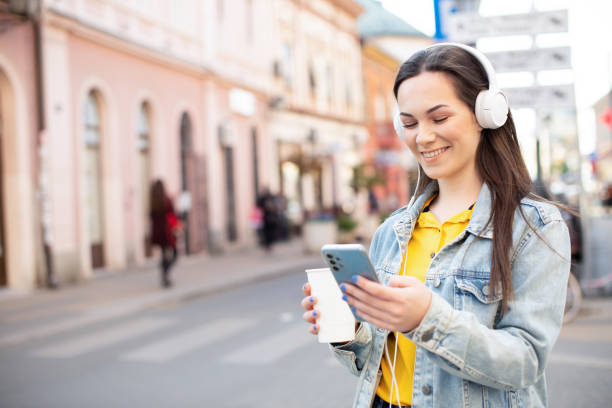 istock Happy young woman using phone 1390925899