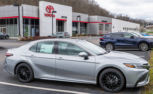 Monroeville, Pennsylvania, USA April 10, 2022 A new silver Toyota sedan for sale at a dealership on a spring day