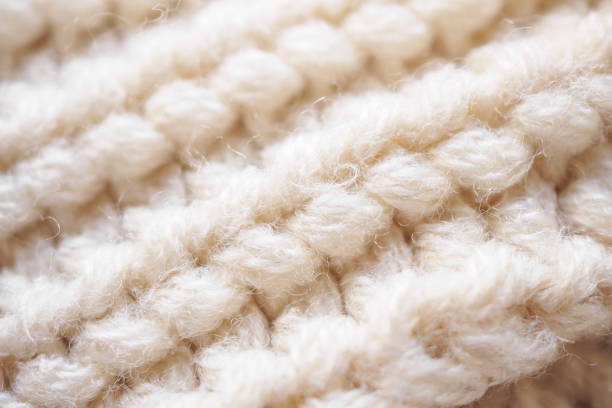 istock closeup beige knitted woolen fabric texture background 1390935013