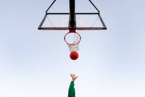 istock hand shooting in a basketball hoop seen from below 1390935844