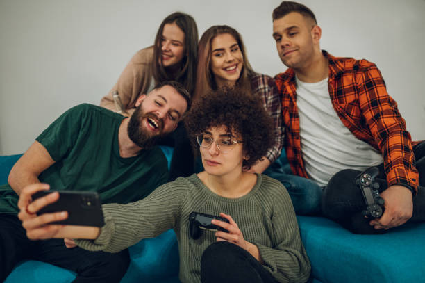 istock Friends having fun at home and taking selfie with a smartphone 1390936205