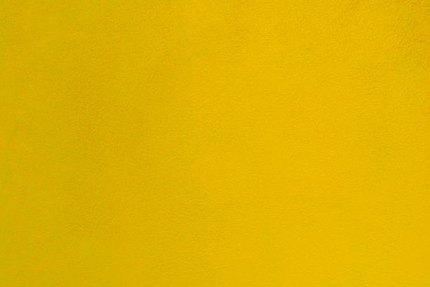 istock brick wall yellow background, Texture plaster backdrop cement concrete, amber mortar abstract rough old solid colors. 1390937372