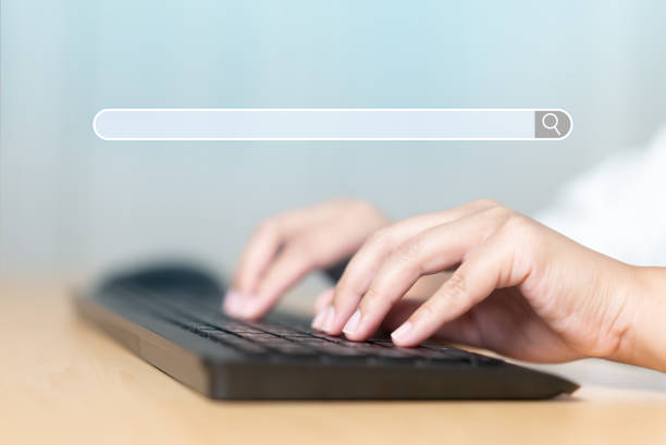 istock Close up of human hand typing on computer keyboard with search engine browser 1390944358