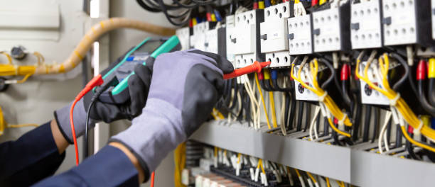 istock Electrician engineer tests electrical installations and wires on relay protection system. Adjustment of scheme of automation and control of electrical equipment. 1390949490