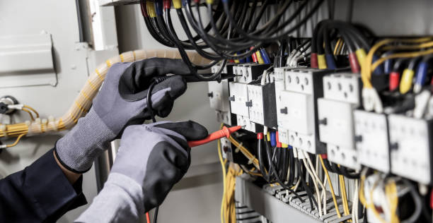 istock Electrician engineer tests electrical installations and wires on relay protection system. Adjustment of scheme of automation and control of electrical equipment. 1390949497