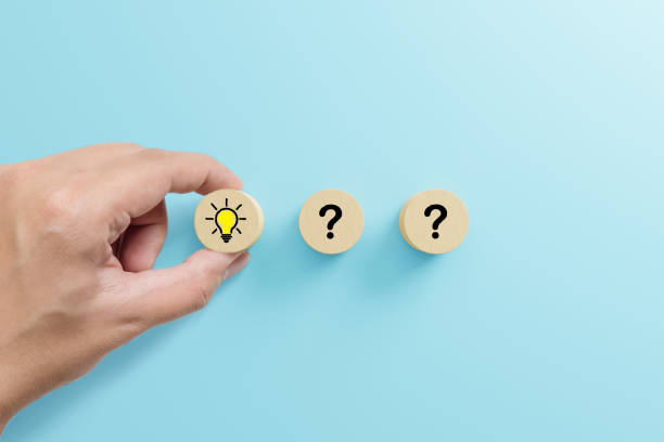 istock Concept creative idea and innovation. Hand choose wooden cube block with head human symbol and light bulb icon 1390951574