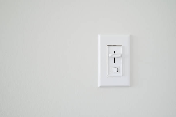 Single Light Dimmer Switch Single light dimmer switch on a blank white wall. dimmer switch photos stock pictures, royalty-free photos & images