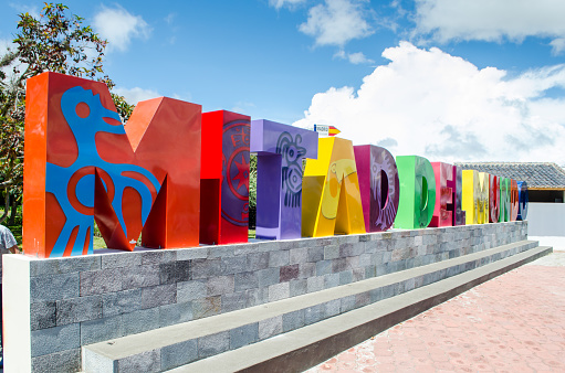 Colorful sign located at the entrance to the Middle of the World Monument in Ciudad Mitad del Mundo in Ecuador