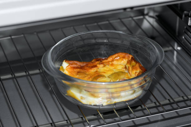 Apple pie in a transparent bowl in the microwave, oven