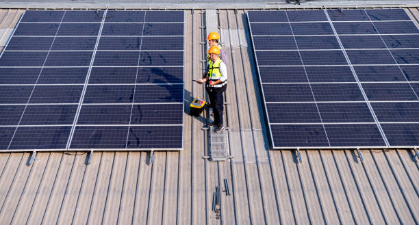 istock Engineers walking on roof inspect and check solar cell panel by hold equipment box and radio communication ,solar cell is smart grid ecology energy sunlight alternative power factory concept. 1390962898