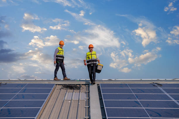Engineers walking on roof inspect and check solar cell panel by hold equipment box and radio communication ,solar cell is smart grid ecology energy sunlight alternative power factory concept.