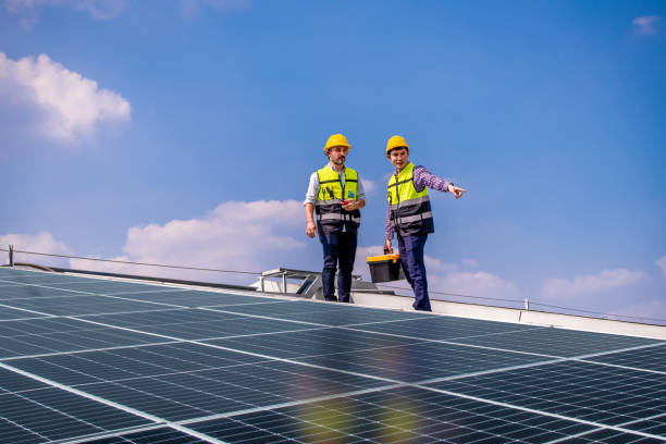 istock Engineers walking on roof inspect and check solar cell panel by hold equipment box and radio communication ,solar cell is smart grid ecology energy sunlight alternative power factory concept. 1390963202
