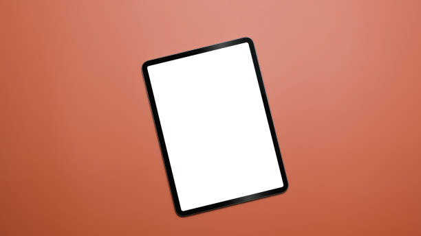 istock Digital tablet with empty screen on orange background with copy space. Top view, Flat lay. 1390964167