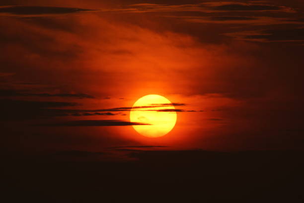 istock Bright Yellow Sun rising in Red Sky 1390964717