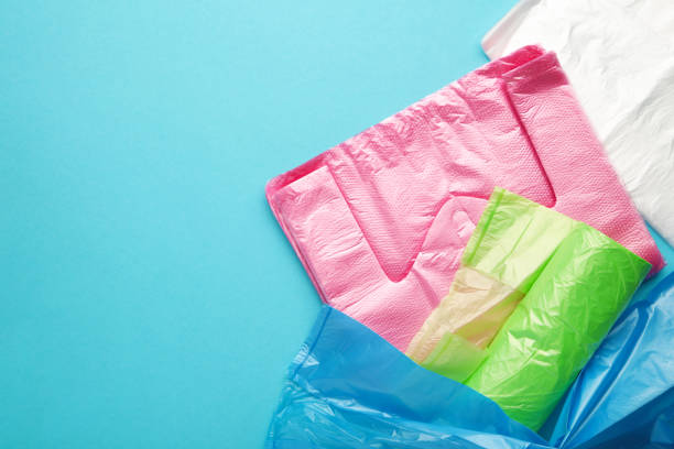 istock A lot of colored plastic bags rolls on a blue background. 1390965238