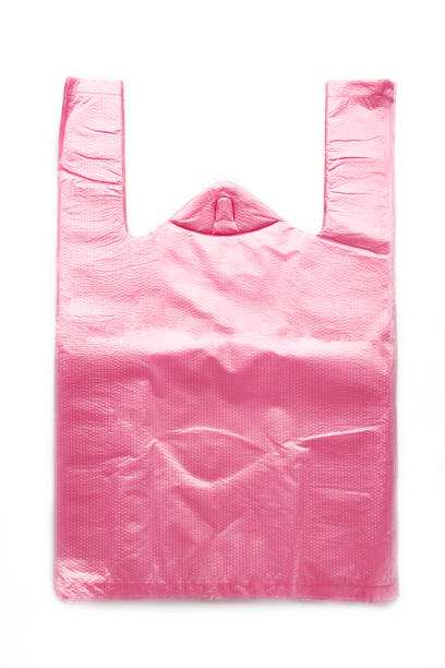 istock Pink plastic bags isolated on white background. Vertical photo. 1390965940
