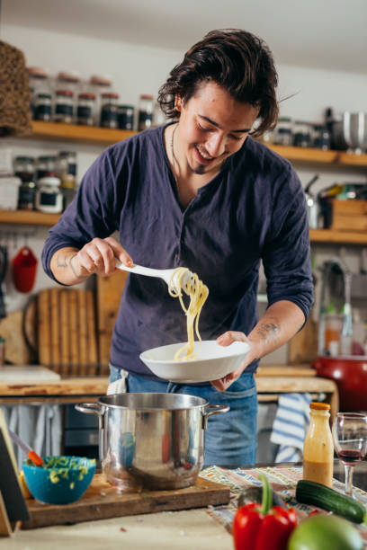 istock man preparing food at home 1390969246