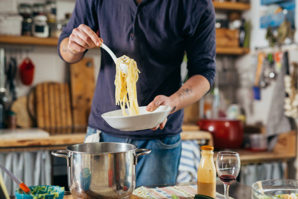 istock man preparing food at home 1390969262