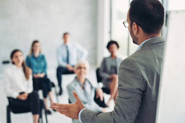 istock Rear view of a businessman speaking during a conference 1390969534
