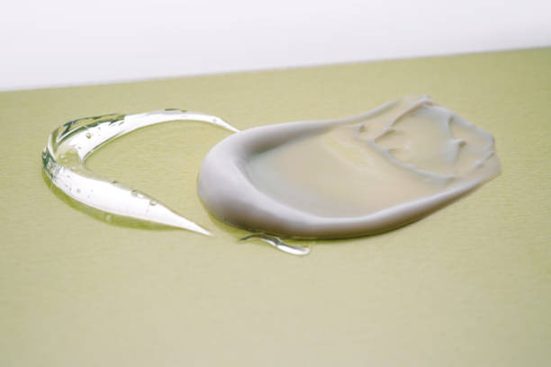 istock Serum and cream on a green background. Textures. 1390970199