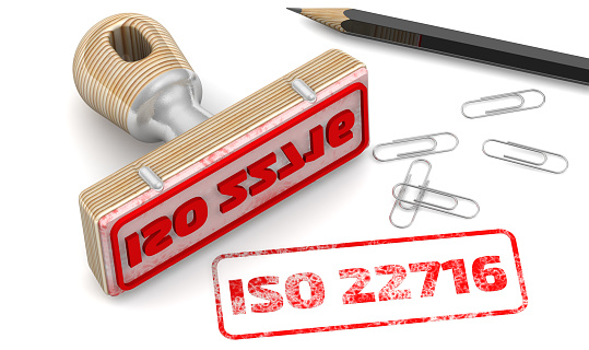 The seal stamp and red imprint ISO 22716 on a white surface. ISO 22716 - Good Manufacturing Practices for Cosmetics. 3D illustration
