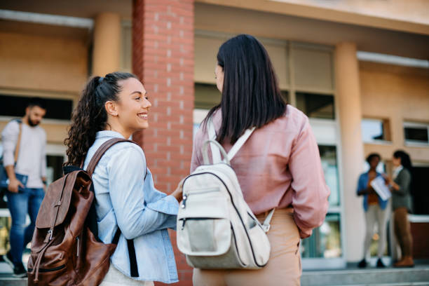 istock Happy female students communicating while going to the lecture at the university. 1390975242