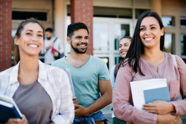 istock Group of happy college students walking after the lecture at campus. 1390975321