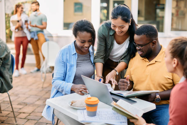 istock Multiracial group of happy college students learning together at cafeteria. 1390975618