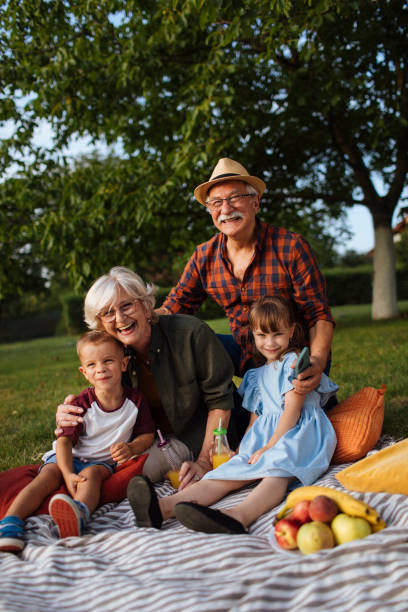 istock Grandparents hugging grandchildren 1390976427