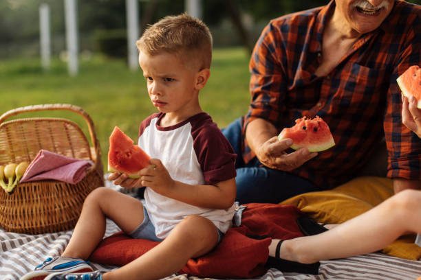 istock Frowning boy with grandparents 1390976452